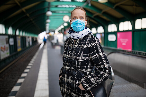 Less people are using public transport since the outbreak of Covid 19 - © iStock by Getty Images Woman wearing mask waiting for the city train at an almost empty Berlin station